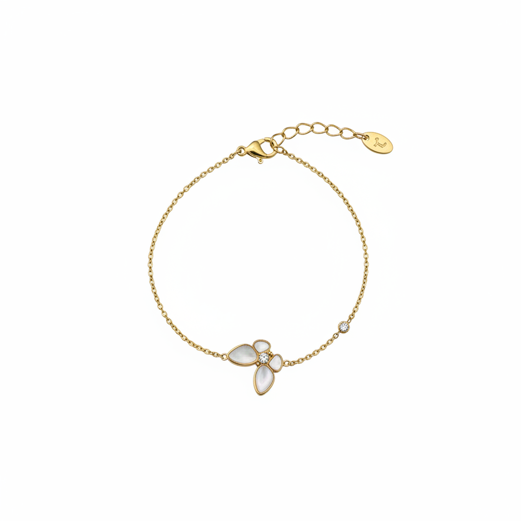 Gold chain bracelet with pearl and crystal flower charm on white background